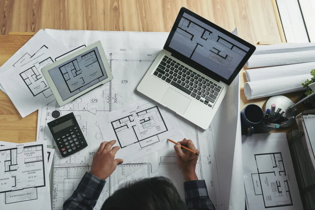 top view unrecognizable person making corrections blueprint sketch 1024x683
